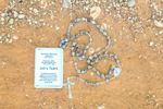 Picture of Job's tears rosary  with Our Lady medal on chain in box
